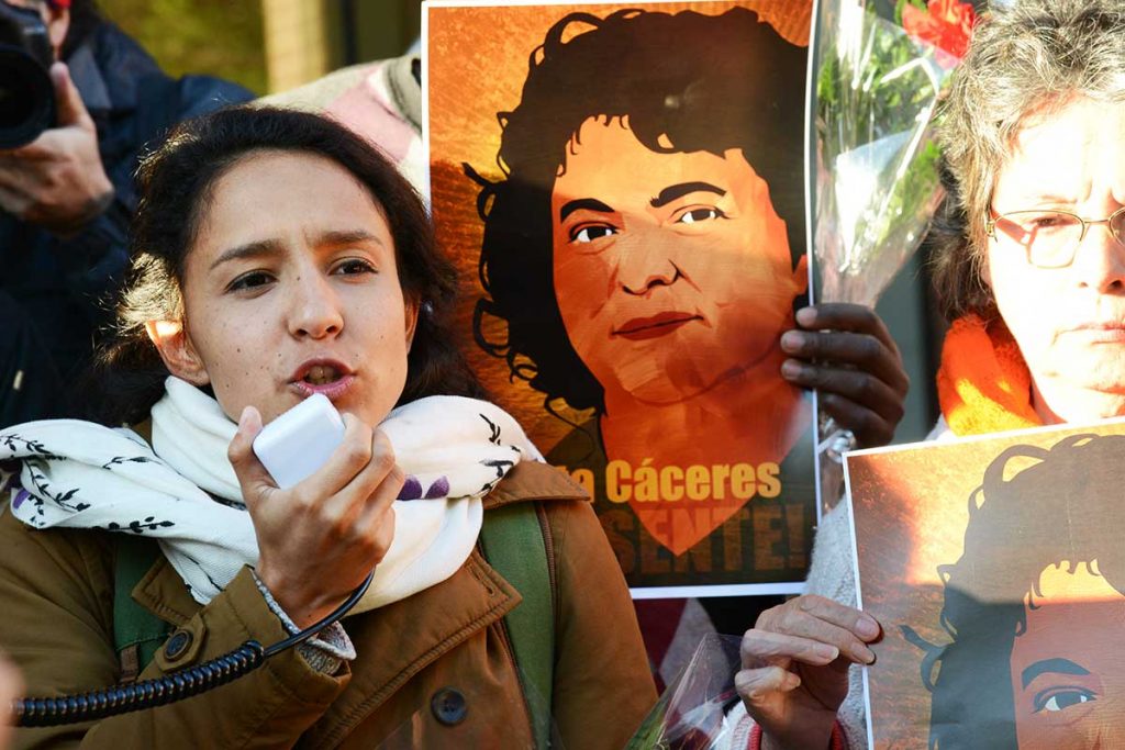 Bertha Caceres speaking outside OAS, 25 April 2016 with a poster of her mother behind her.