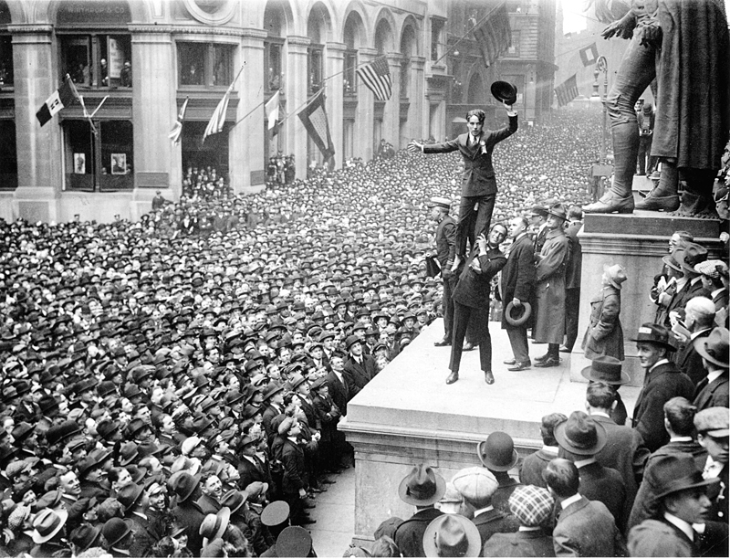 Charlie Chaplin stands on Douglas Fairbanks' shoulders during a Liberty bonds rally. Liberty bonds were war bonds sold to support the allied cause in World War I. The bonds introduced the idea of financial securities to many citizens for the first time. Credit: Wikimedia/Public Domain images for the New York Times